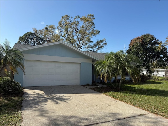 ranch-style home featuring a front yard, driveway, an attached garage, a shingled roof, and stucco siding