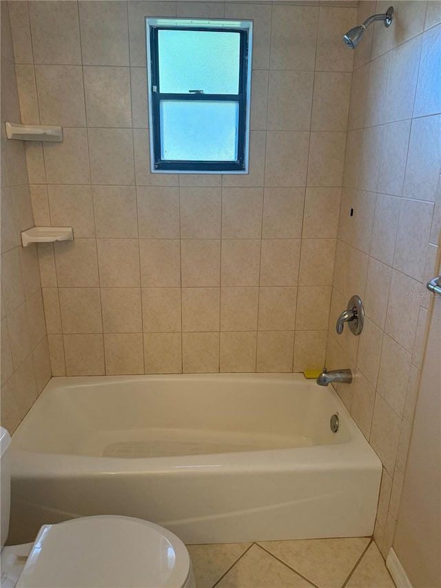 full bath with shower / bath combination, toilet, and tile patterned flooring