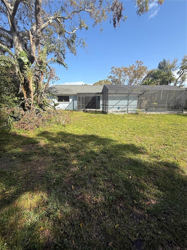 view of yard with glass enclosure