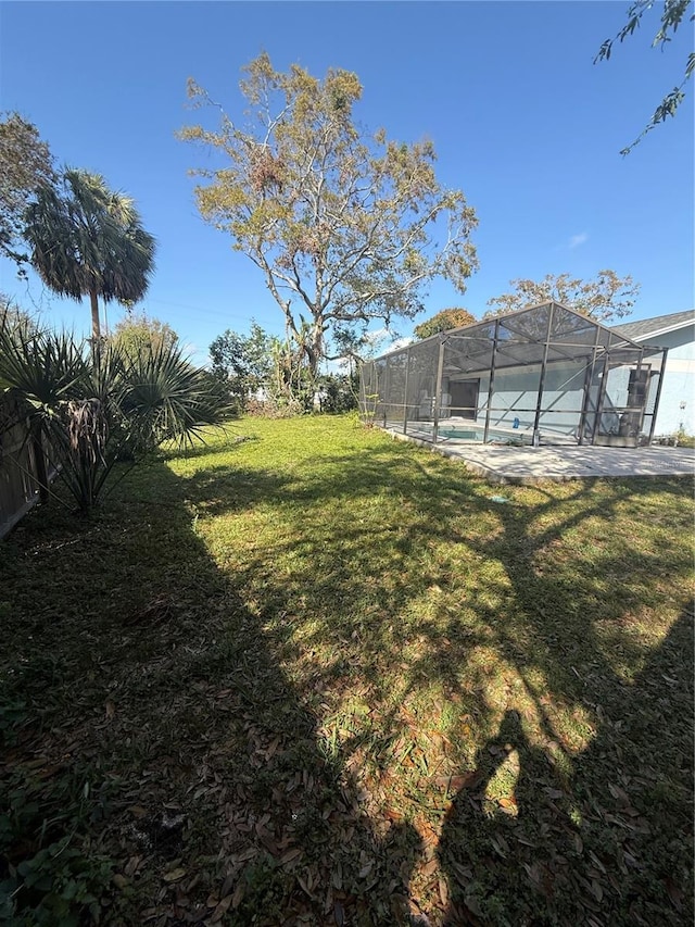 view of yard with a lanai and a pool