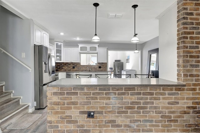 4716 Gazania St, New Port Richey, FL 34652 - kitchen featuring appliances with stainless steel finishes, decorative backsplash, visible vents, and white cabinets