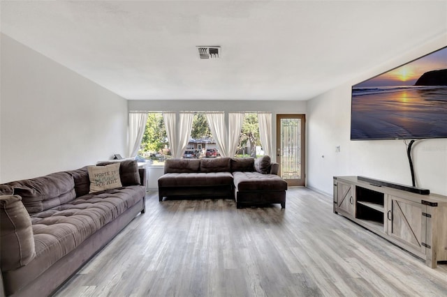 4716 Gazania St, New Port Richey, FL 34652 - living area featuring baseboards, visible vents, and light wood-style floors