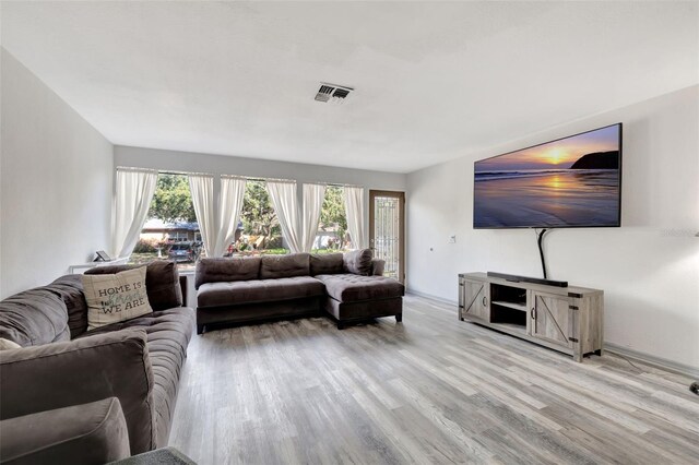 4716 Gazania St, New Port Richey, FL 34652 - living area with baseboards, visible vents, and wood finished floors