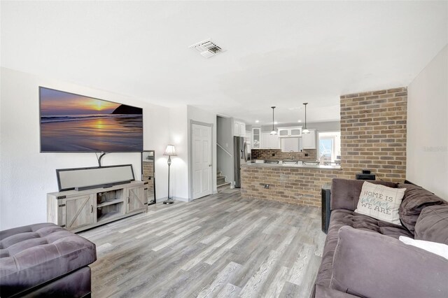 4716 Gazania St, New Port Richey, FL 34652 - living room featuring light wood-type flooring, visible vents, and baseboards