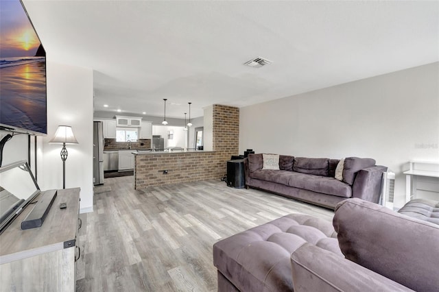 4716 Gazania St, New Port Richey, FL 34652 - living room featuring light wood finished floors and visible vents