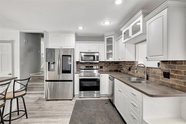 4716 Gazania St, New Port Richey, FL 34652 - kitchen featuring stainless steel appliances, white cabinets, a sink, and decorative backsplash