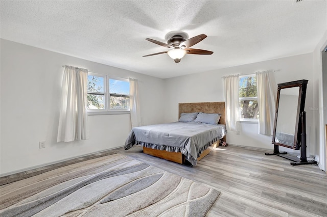 4716 Gazania St, New Port Richey, FL 34652 - bedroom with ceiling fan, a textured ceiling, and wood finished floors