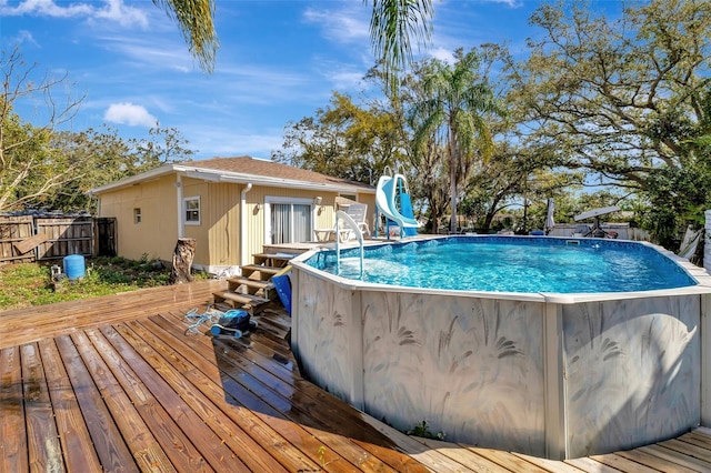 4716 Gazania St, New Port Richey, FL 34652 - view of swimming pool with fence, a deck, a fenced in pool, and a water slide