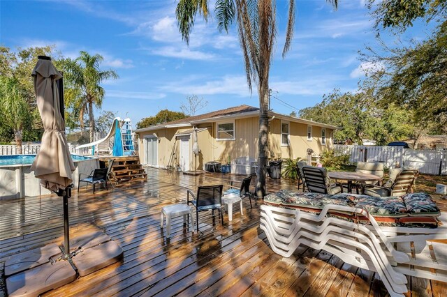 4716 Gazania St, New Port Richey, FL 34652 - deck featuring outdoor dining space, fence, and a fenced in pool