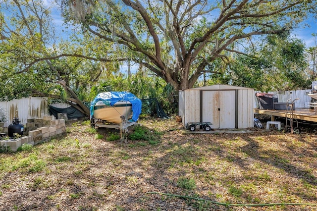 4716 Gazania St, New Port Richey, FL 34652 - view of yard featuring fence, a storage unit, and an outbuilding