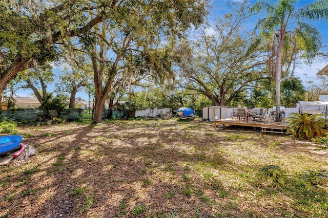 4716 Gazania St, New Port Richey, FL 34652 - view of yard featuring an outbuilding, a storage unit, fence, and a deck
