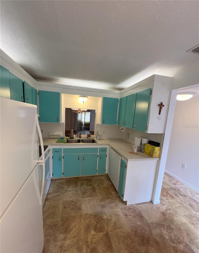 kitchen featuring light countertops, white appliances, a sink, and visible vents