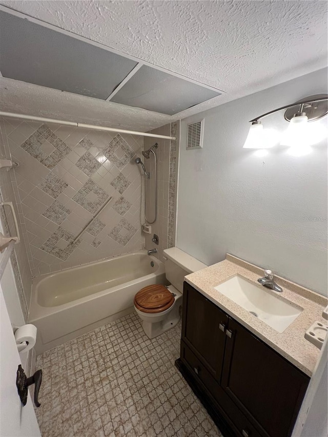 bathroom with visible vents, bathing tub / shower combination, toilet, a textured ceiling, and vanity