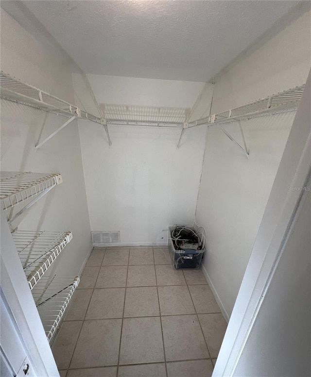 spacious closet featuring tile patterned flooring and visible vents