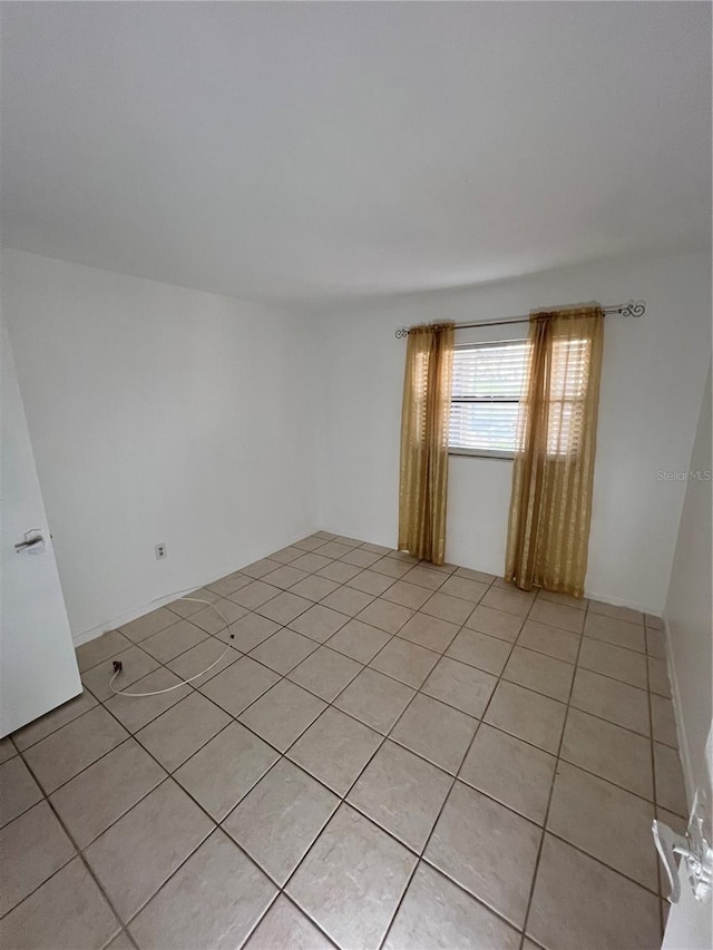 unfurnished room featuring light tile patterned floors