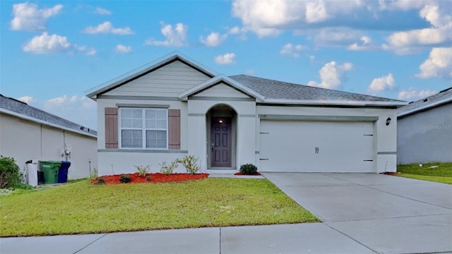 ranch-style home featuring stucco siding, a shingled roof, concrete driveway, an attached garage, and a front yard