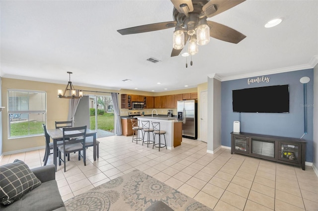 living room featuring crown molding, light tile patterned floors, recessed lighting, visible vents, and baseboards