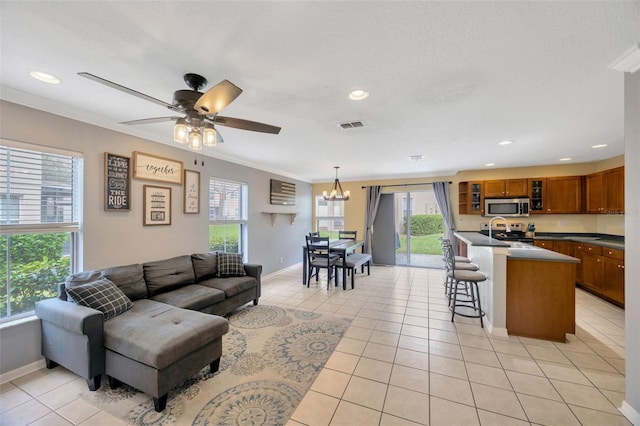 living area featuring light tile patterned floors, plenty of natural light, and visible vents