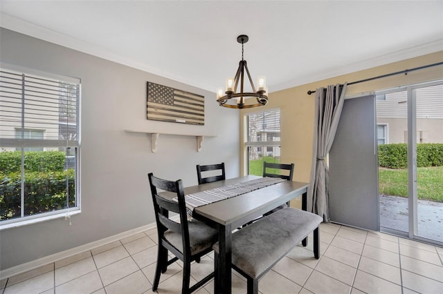 dining room with ornamental molding, a notable chandelier, baseboards, and light tile patterned floors