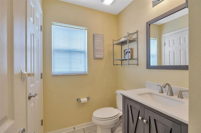 bathroom with tile patterned floors, vanity, toilet, and baseboards