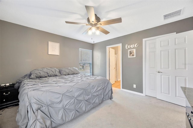 bedroom featuring baseboards, visible vents, ceiling fan, and light colored carpet