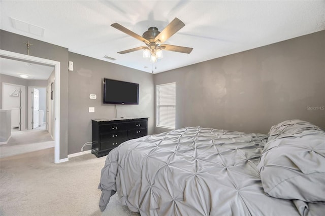 bedroom featuring a ceiling fan, visible vents, light carpet, and baseboards