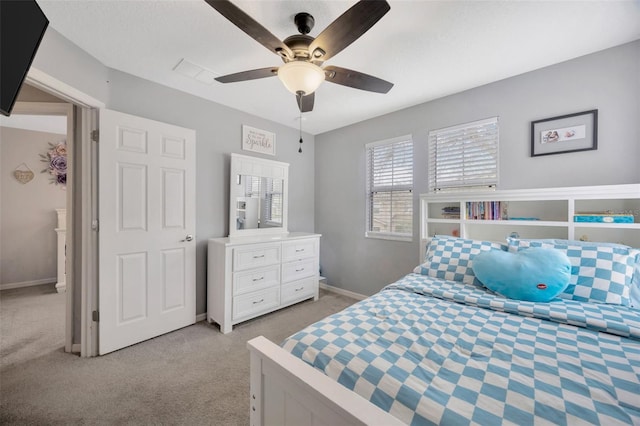 bedroom with light carpet, ceiling fan, and baseboards