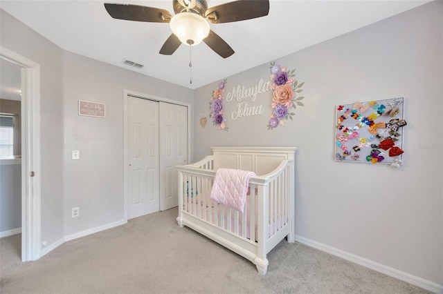 bedroom featuring light carpet, baseboards, visible vents, and a closet