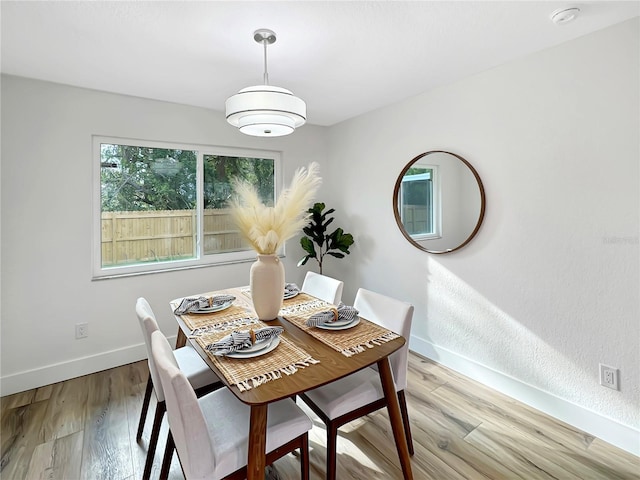 dining area featuring baseboards and wood finished floors