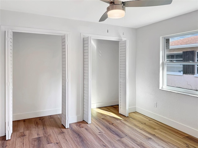 unfurnished bedroom featuring wood finished floors, a ceiling fan, and baseboards