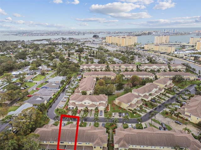 birds eye view of property with a water view and a residential view