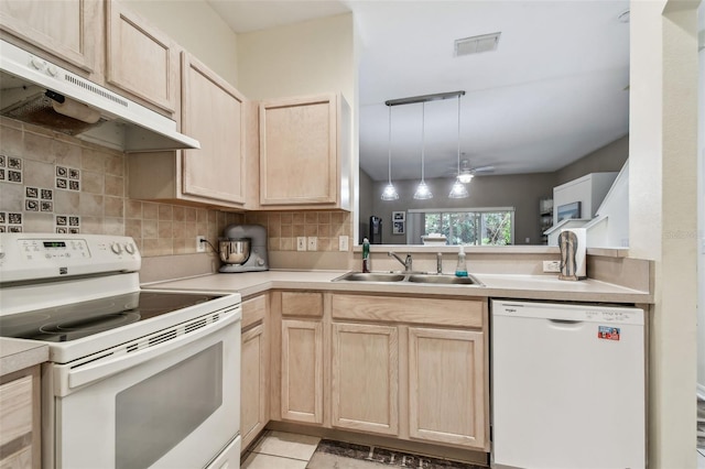 kitchen featuring white appliances, light brown cabinets, under cabinet range hood, and visible vents