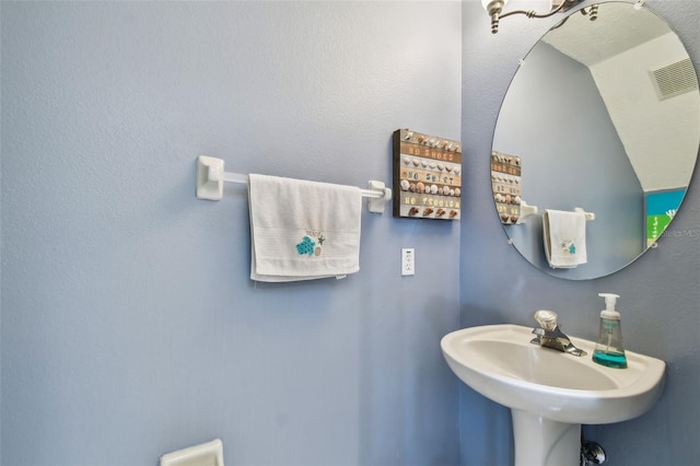 bathroom featuring a sink and visible vents