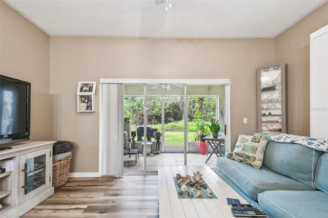 living room with light wood finished floors and baseboards