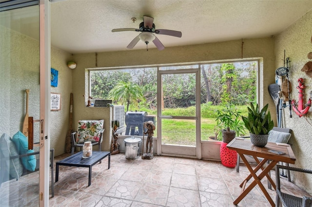 sunroom / solarium featuring ceiling fan