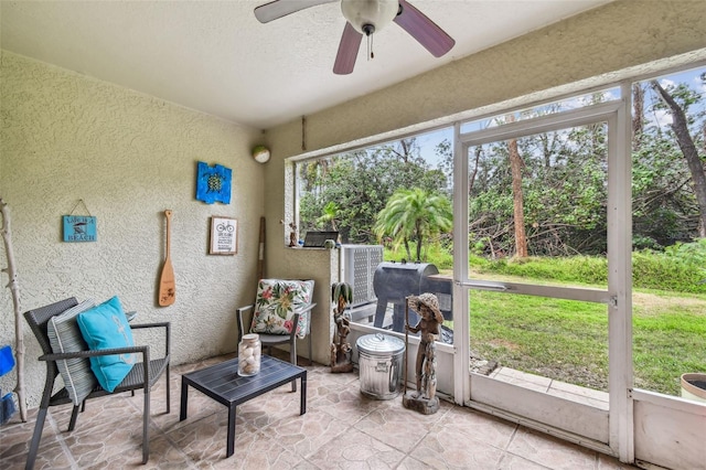 sunroom featuring a healthy amount of sunlight and ceiling fan