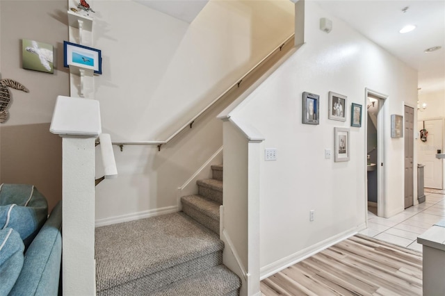 stairway featuring baseboards and recessed lighting