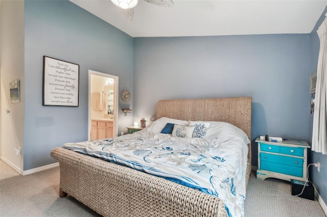 bedroom featuring light carpet, baseboards, and ensuite bathroom