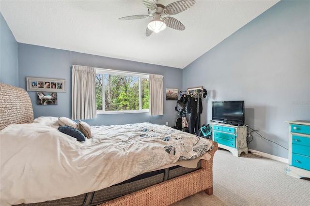 carpeted bedroom featuring a ceiling fan, vaulted ceiling, and baseboards