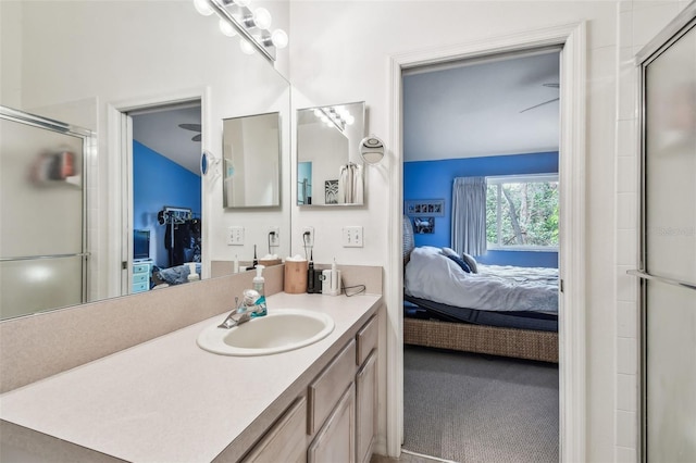 ensuite bathroom with a shower with door, ensuite bath, and vanity