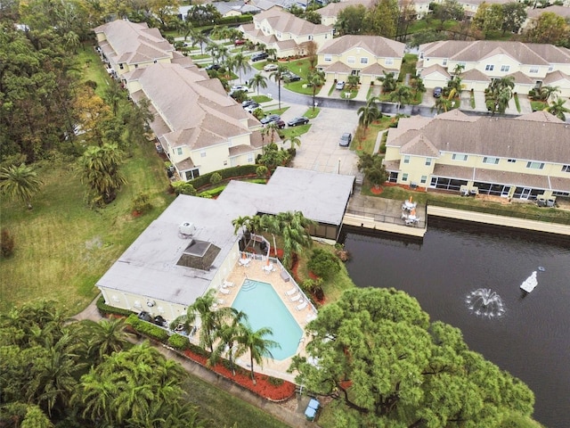 drone / aerial view with a water view and a residential view