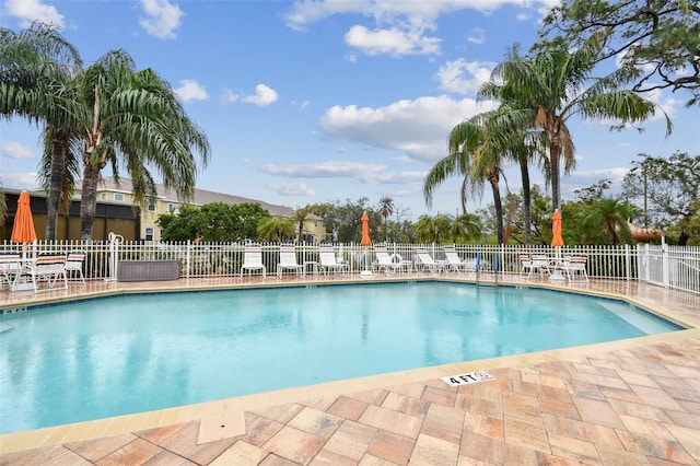 pool featuring fence and a patio