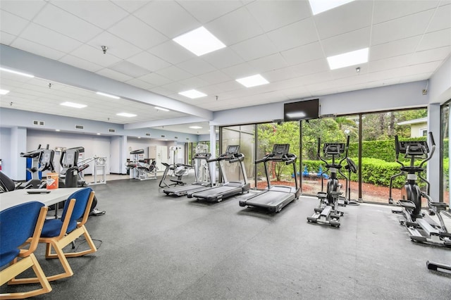 exercise room featuring a paneled ceiling and visible vents