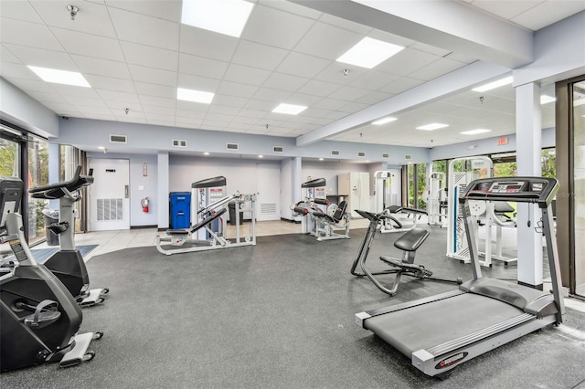 exercise room featuring a paneled ceiling and visible vents