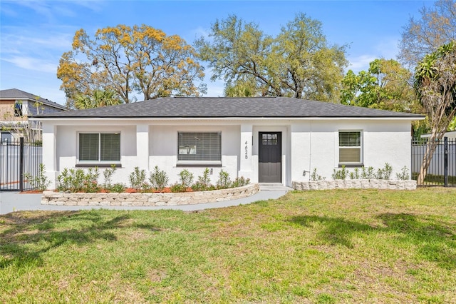 ranch-style house with fence, a front lawn, and stucco siding