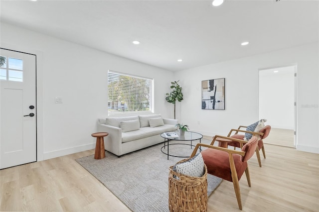 living area featuring recessed lighting, baseboards, and light wood finished floors