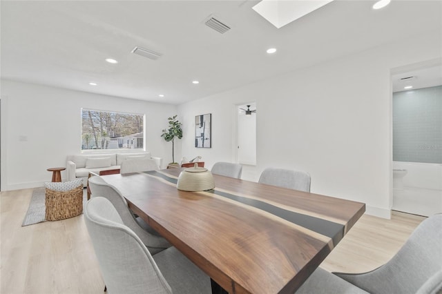 dining area featuring recessed lighting, a skylight, visible vents, and light wood-style floors