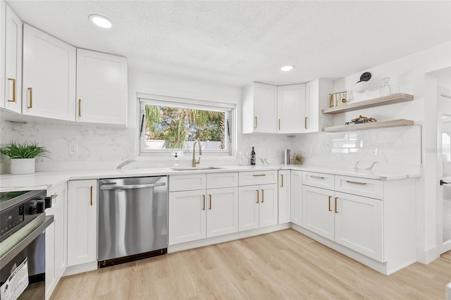 kitchen with stove, a sink, white cabinetry, dishwasher, and light wood finished floors