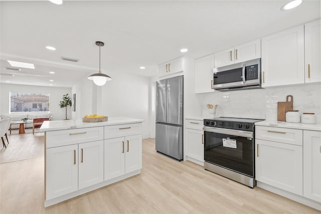 kitchen with visible vents, white cabinets, appliances with stainless steel finishes, light countertops, and light wood-type flooring