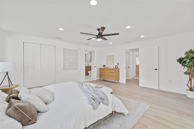 bedroom featuring light wood-type flooring, ensuite bath, baseboards, and recessed lighting